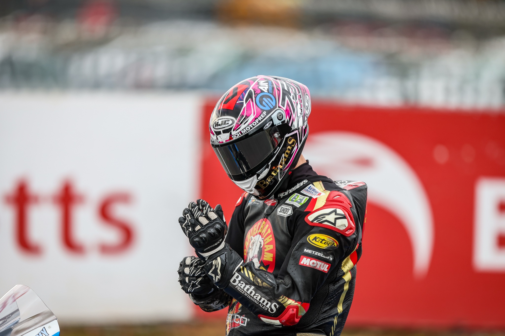 Christian Smith in helmet and race leathers preparing before the start