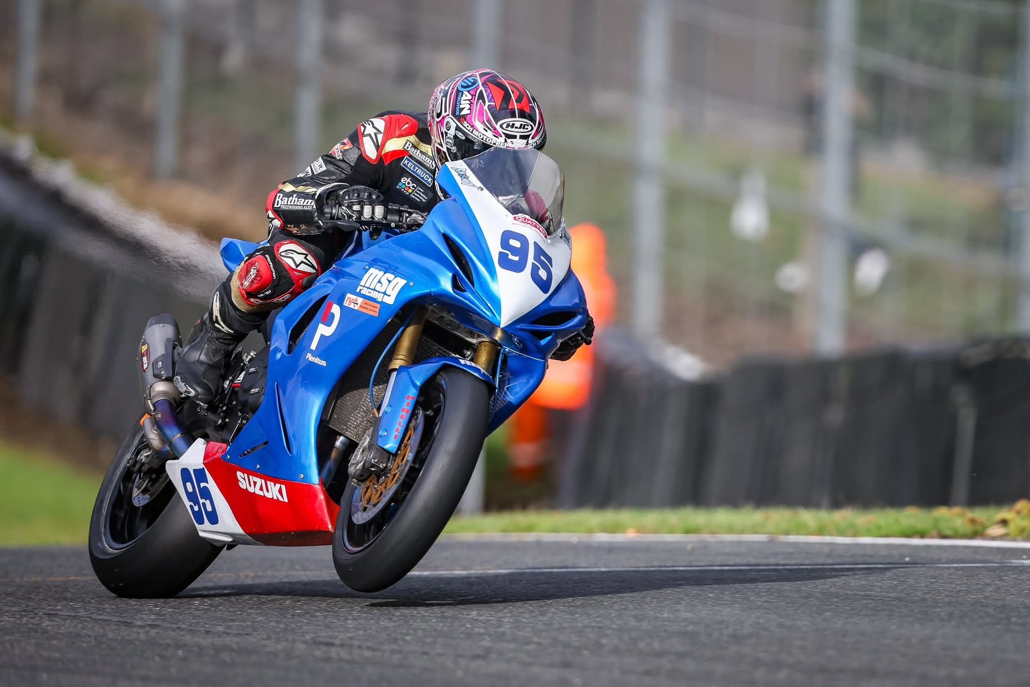 Christian Smith riding the blue number 95 Suzuki race bike on track