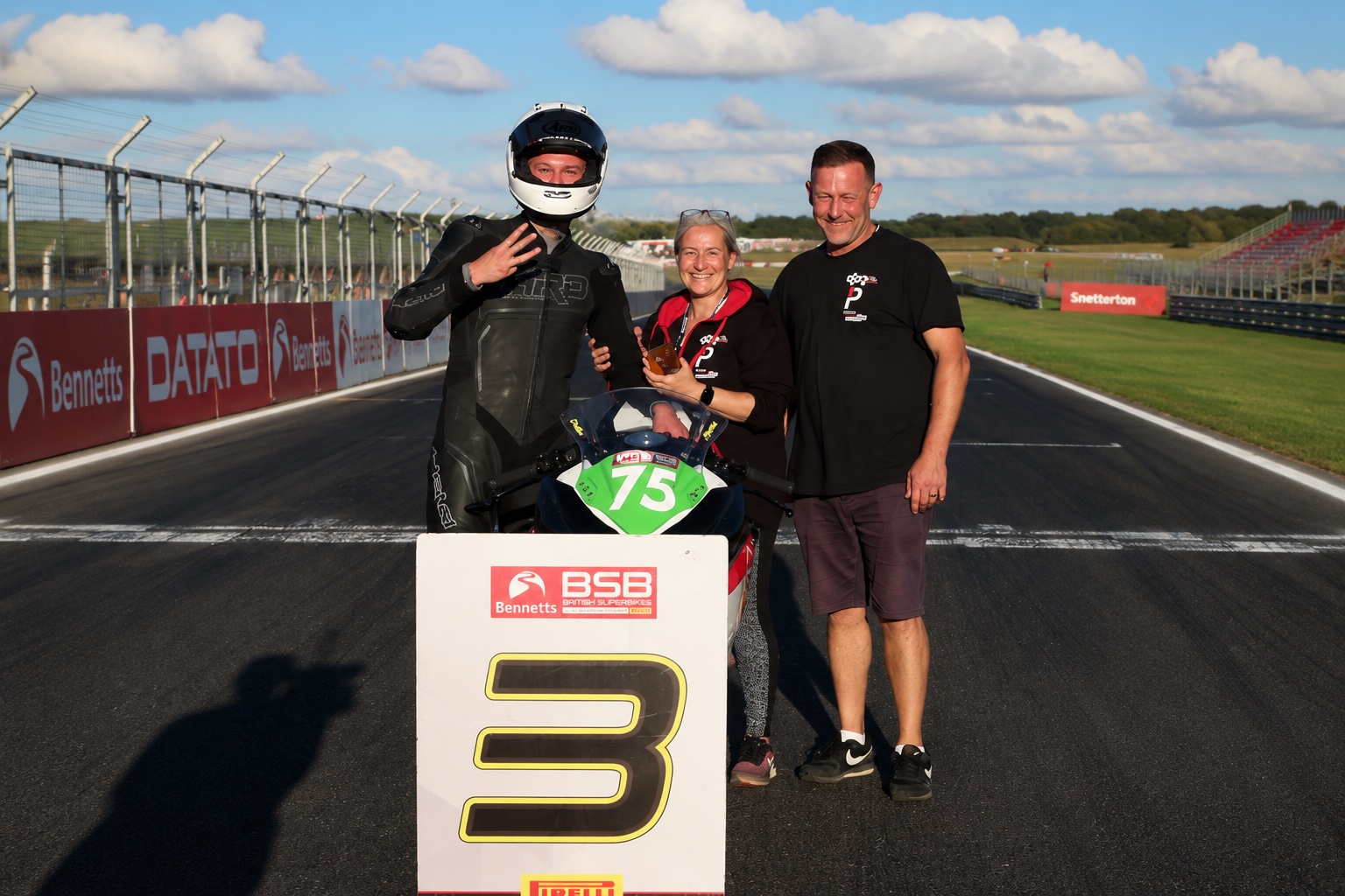 Christian Smith celebrating his first BSB podium with his team at Snetterton