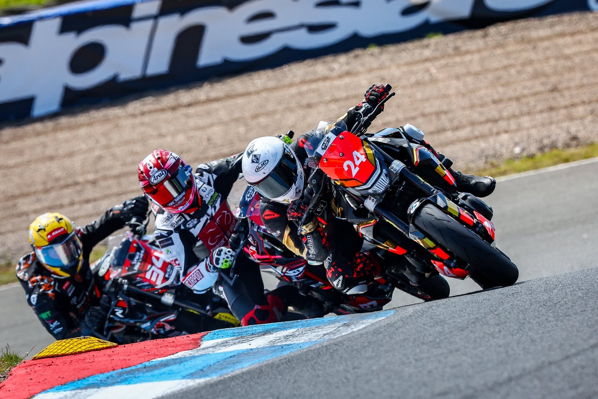 Kieran Smith riding number 24 in a close pack through a corner