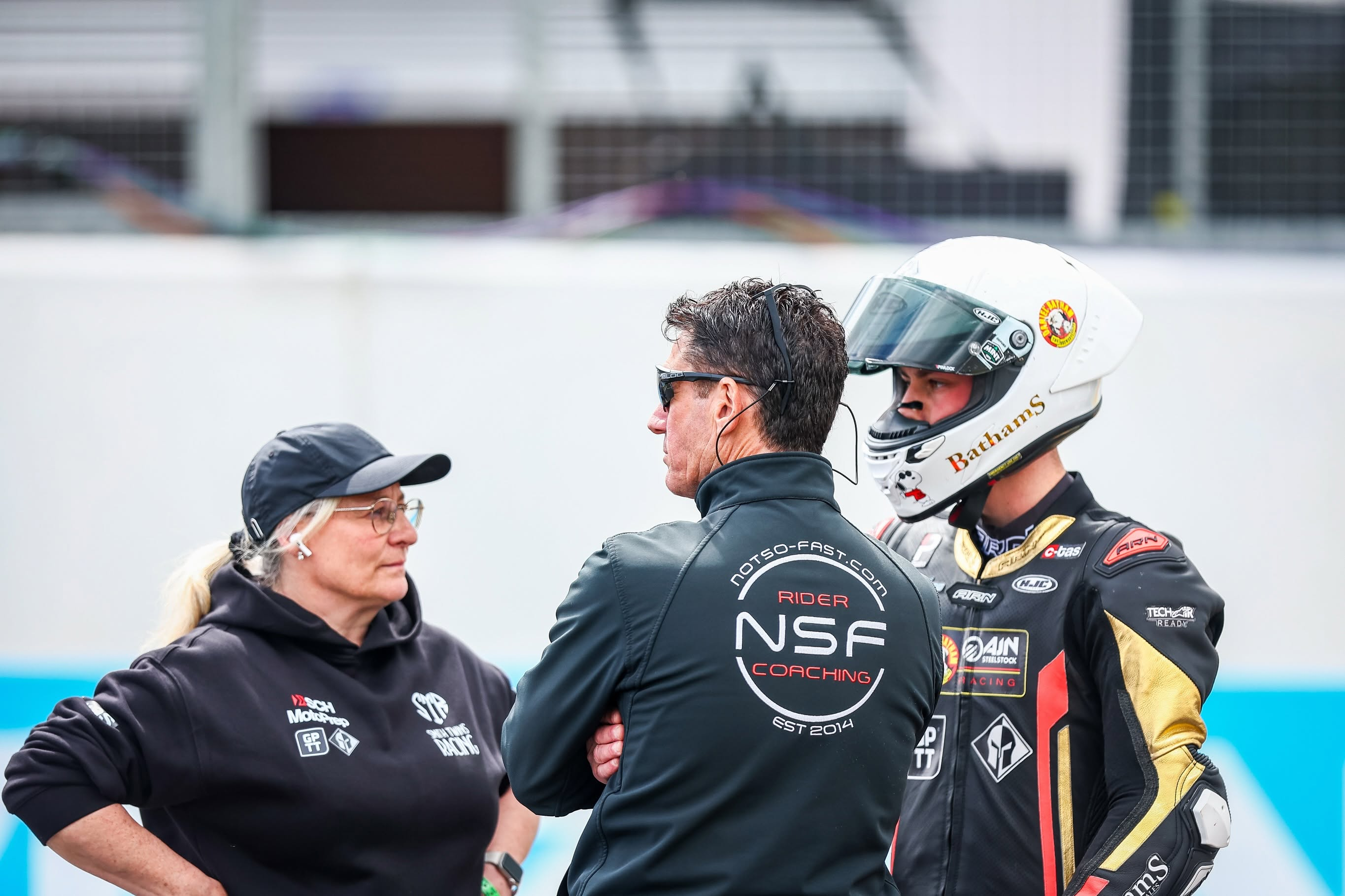 Kieran Smith in helmet listening during a race-day briefing