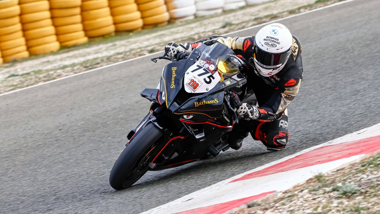 Smith Twins rider number 75 leaning through a right-hand corner on track