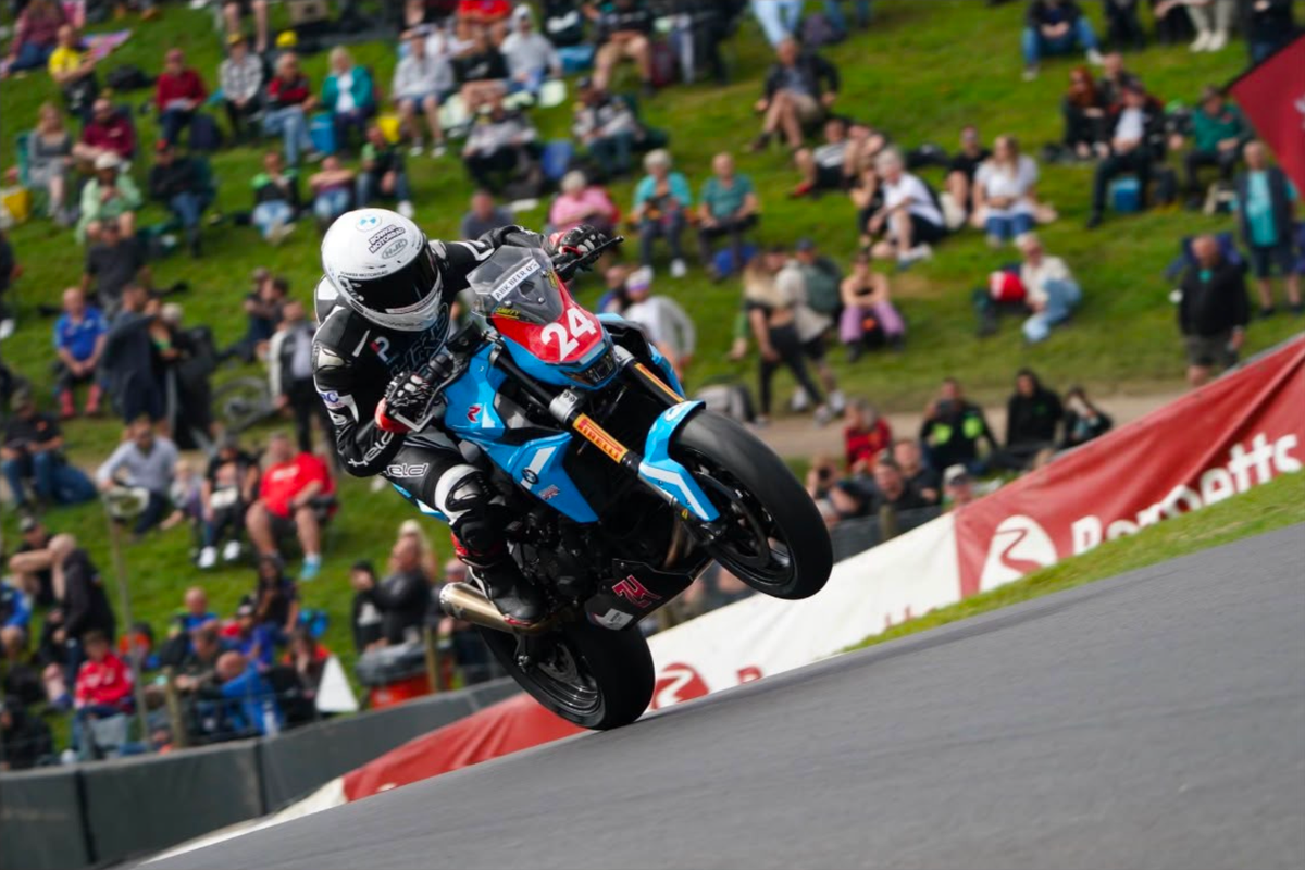 Kieran Smith lifting the front wheel of race bike number 24 during his first BMW F900R Cup heat race win