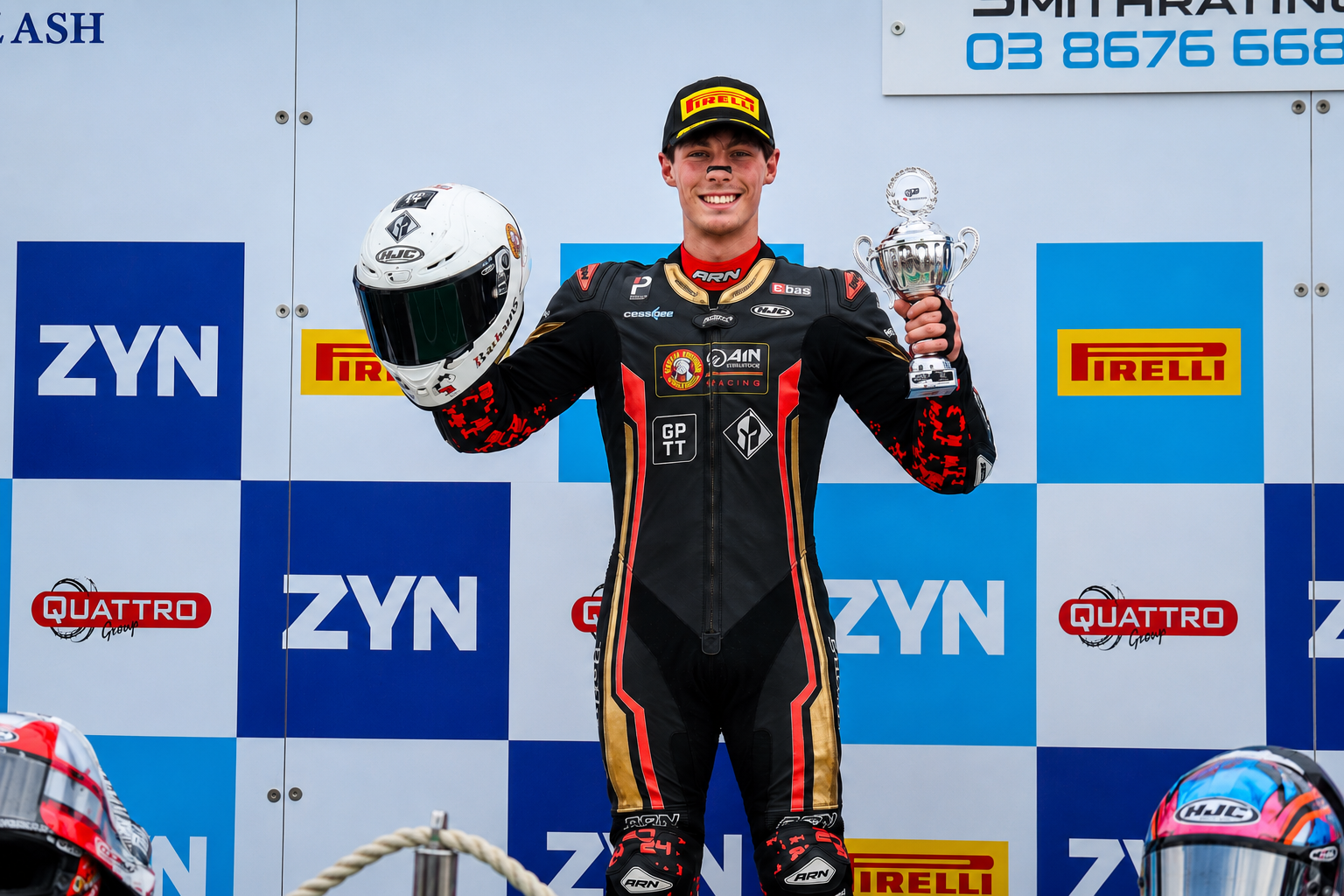 Kieran Smith holding his helmet and trophy after taking the lead in the British Superbike Championship standings for the first time