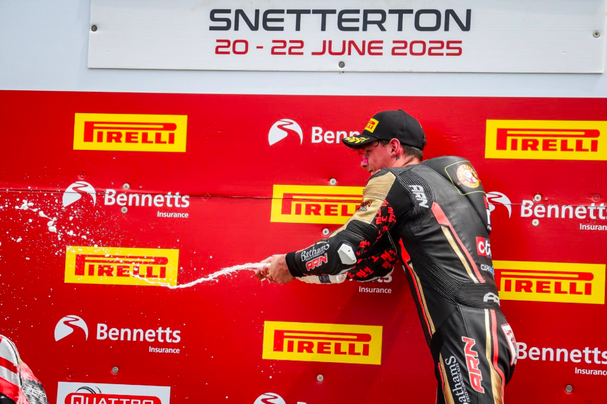 Kieran Smith spraying champagne to celebrate his first British Superbike Championship podium at Snetterton in June 2025