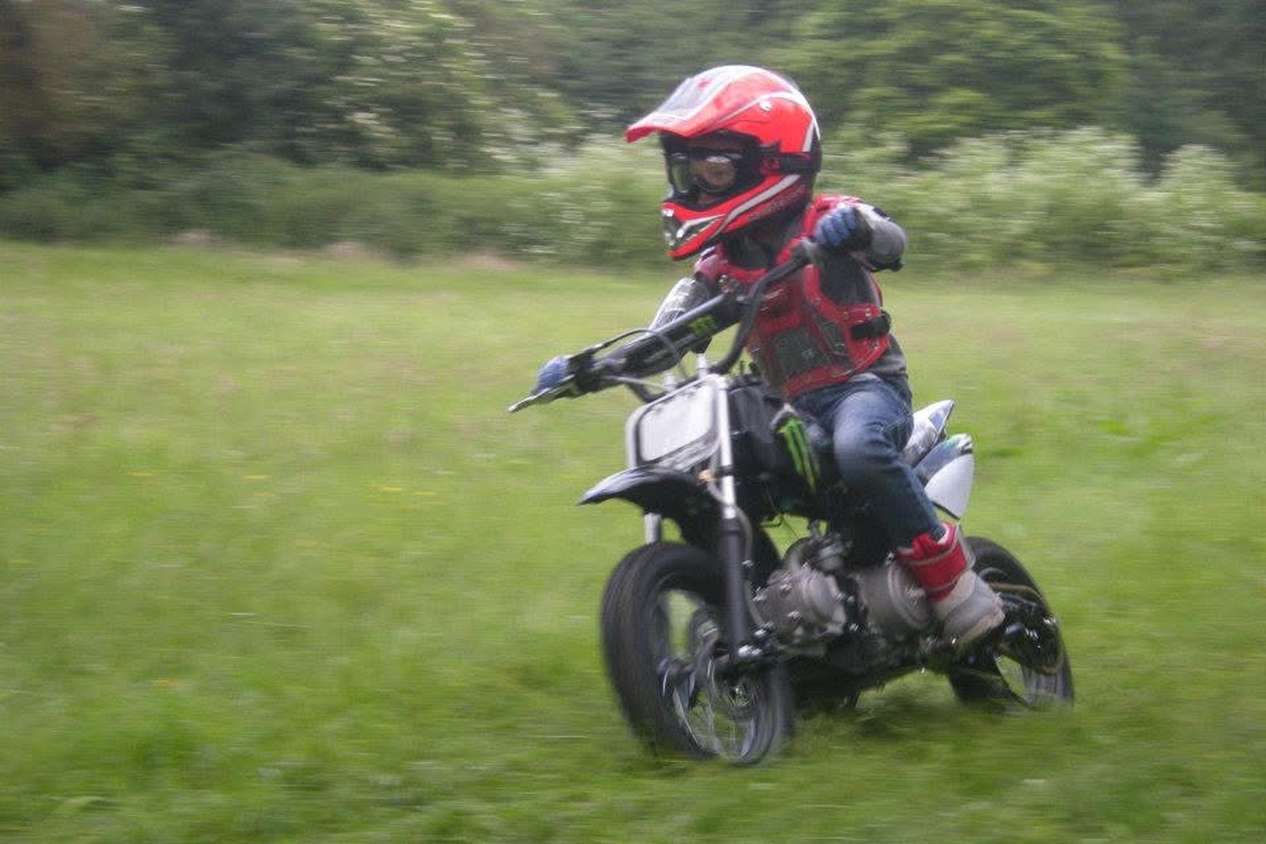 Young rider on a minibike in a field