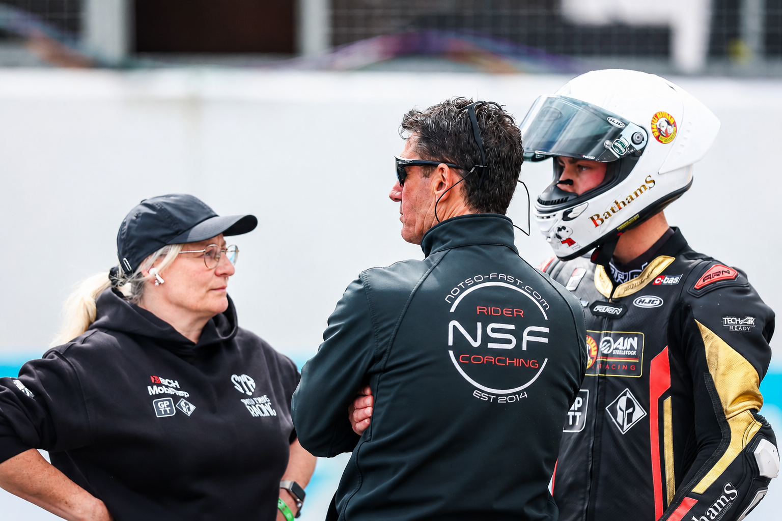 Rider with coach and team member