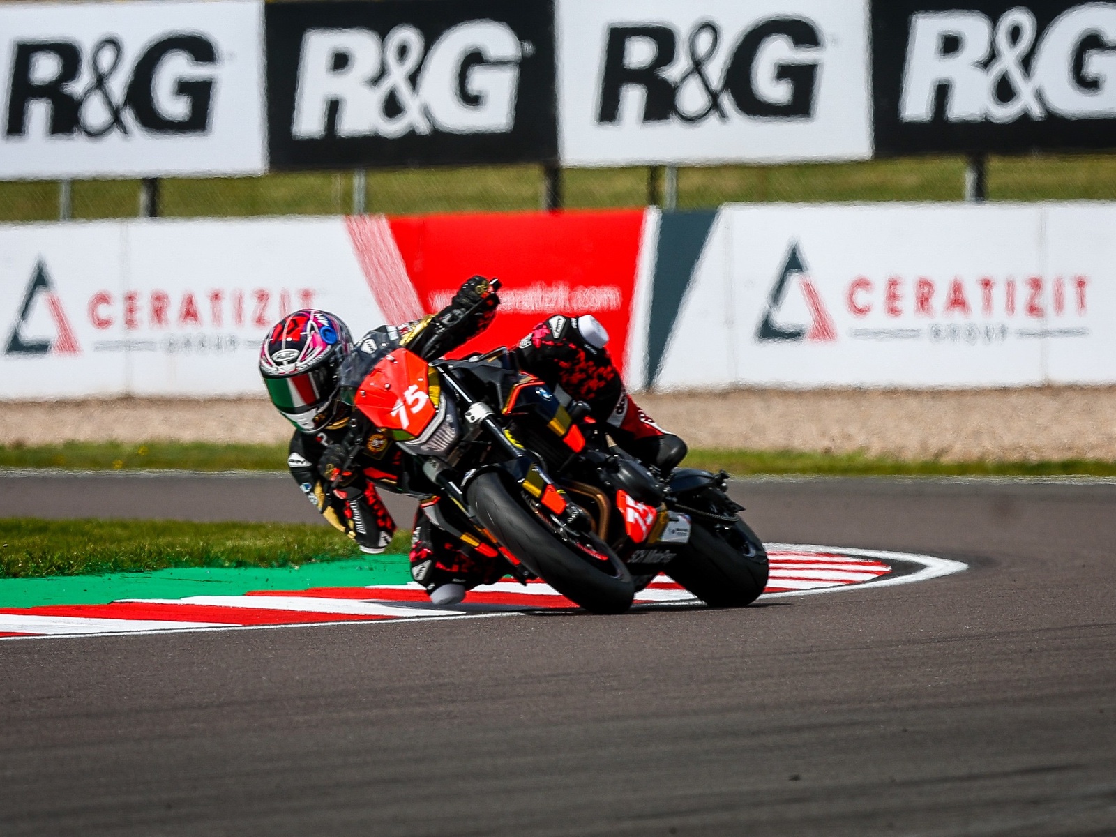 Christian Smith leaning through a Donington Park corner on his number 75 bike