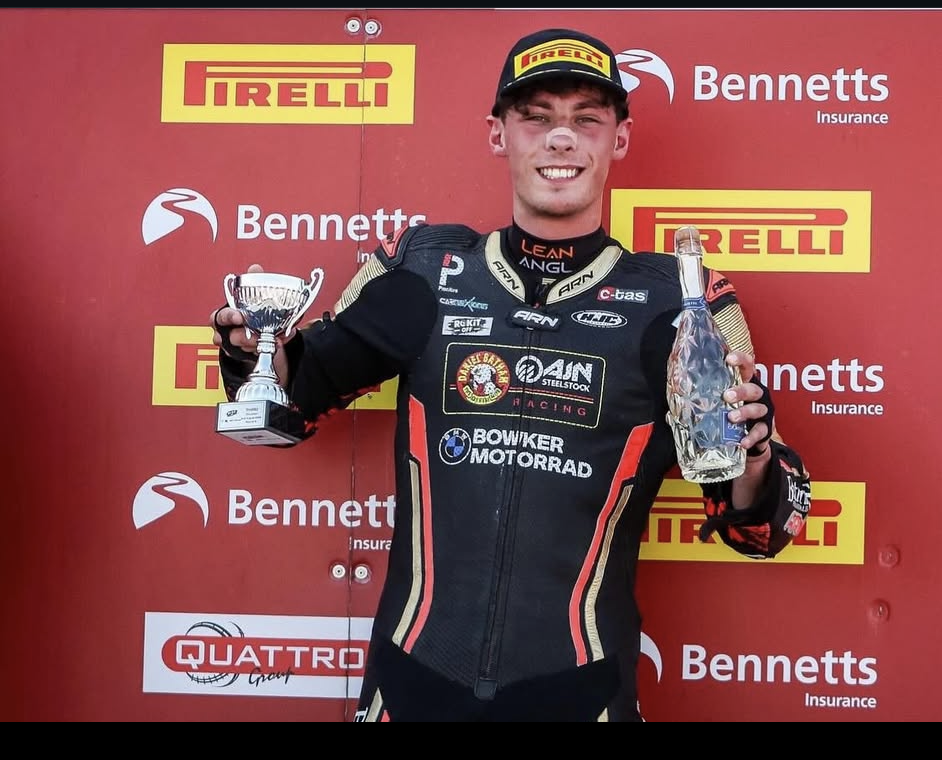 Kieran Smith holding trophies on the Bennetts podium